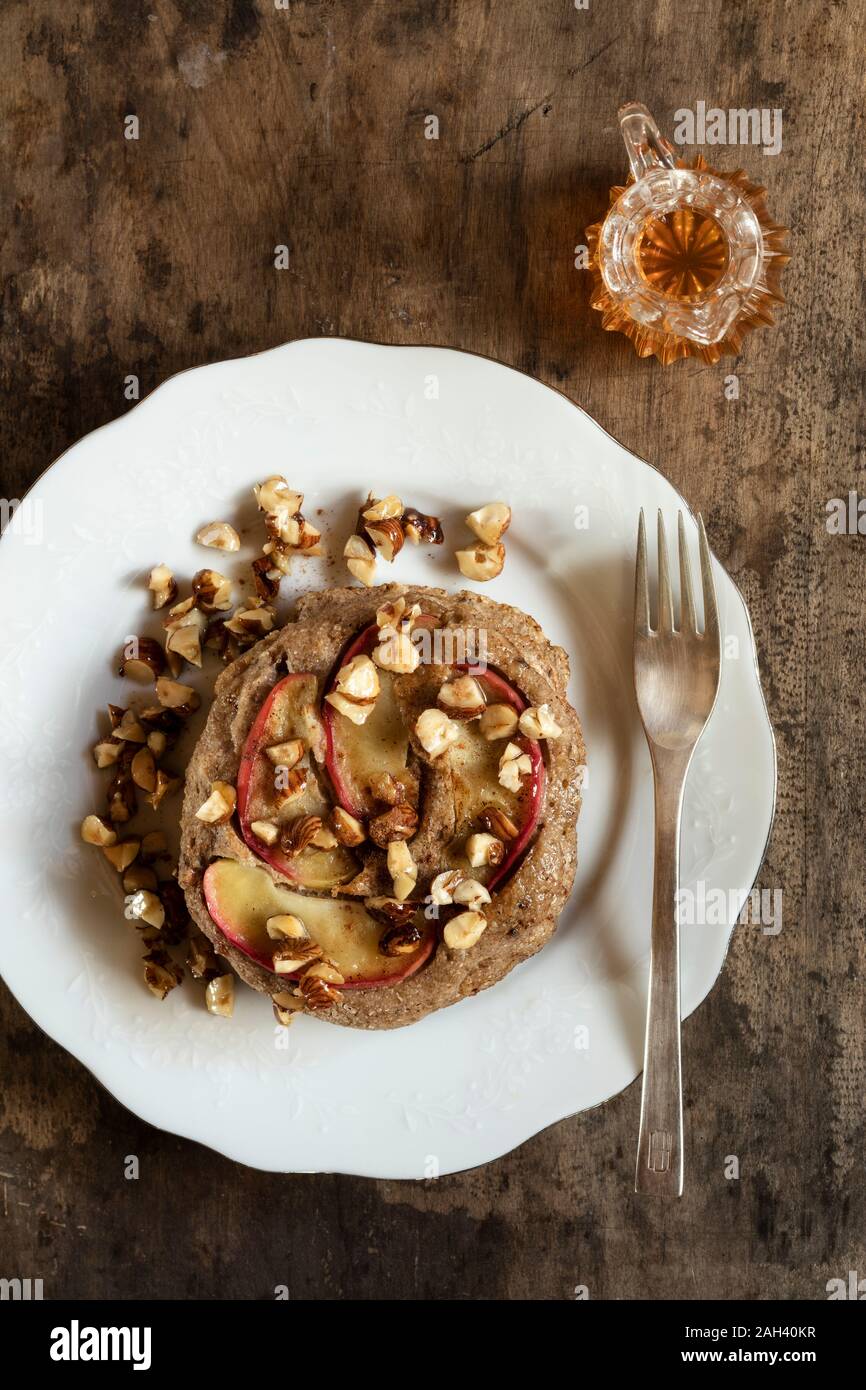 Plate of gluten free buckwheat pancakes with banana, apple and nuts Stock Photo