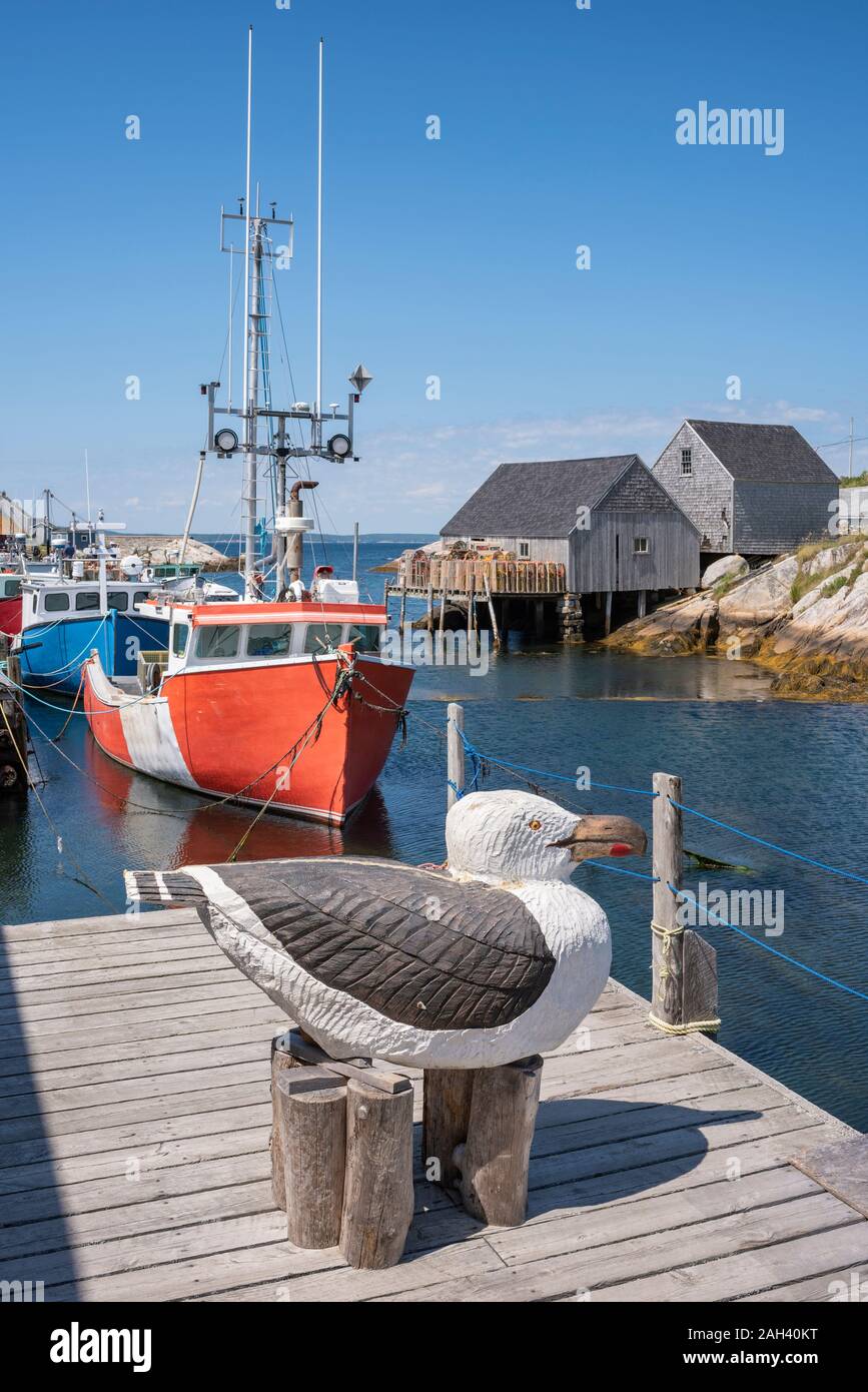 Canada, Nova Scotia, Peggys Cove, Wooden sculpture of herring gull in harbor Stock Photo