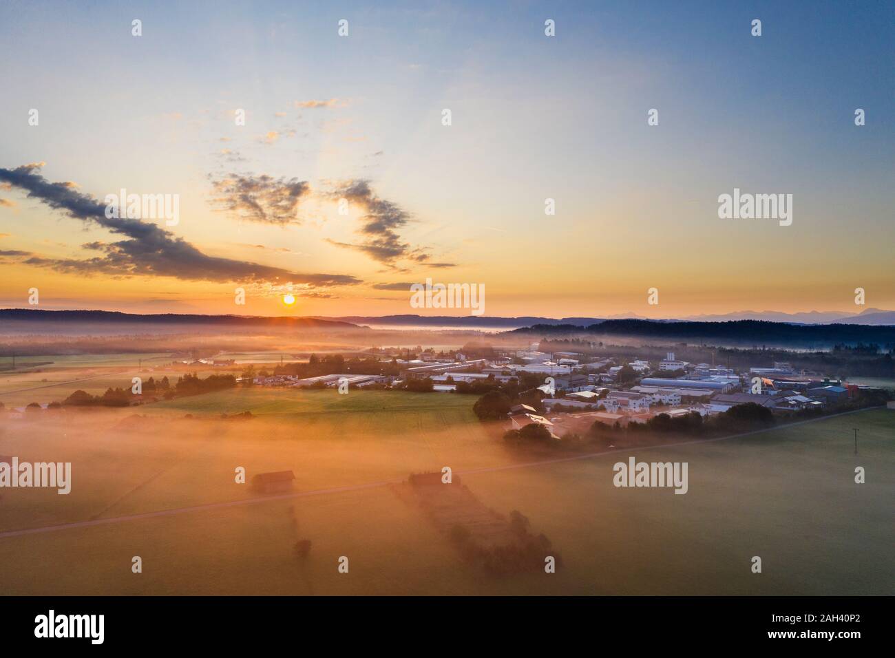 Germany, Bavaria, Geretsried, Aerial view of countryside town at foggy sunrise Stock Photo