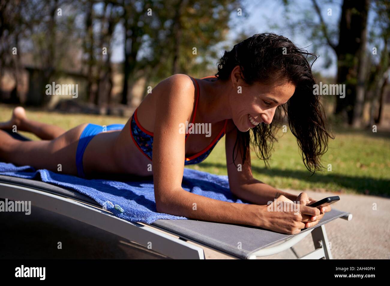 Woman lying down in bikini hi-res stock photography and images - Alamy