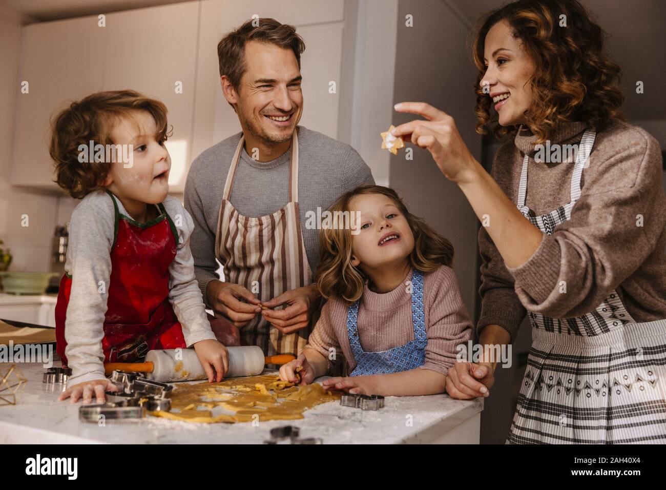 Family preparing Christmas cookies in kitchen Stock Photo