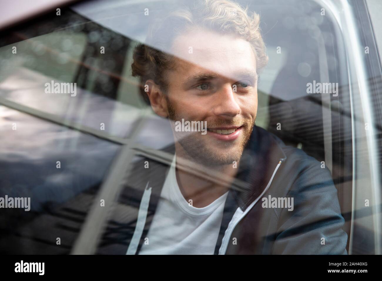 Young man getting out of the car Stock Photo