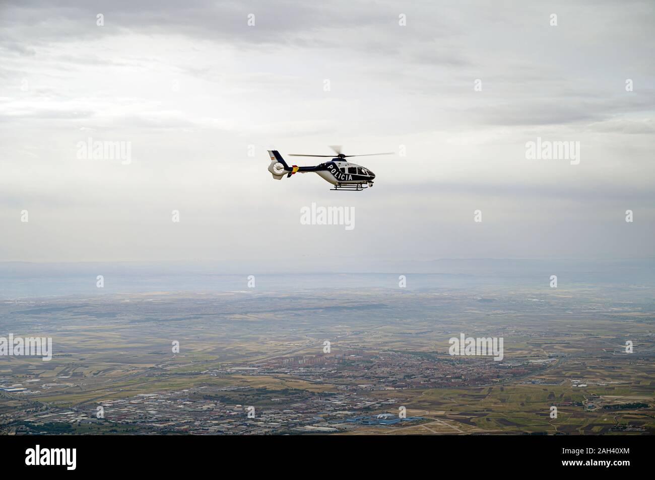 Spain, Madrid, Police helicopter flying above city Stock Photo
