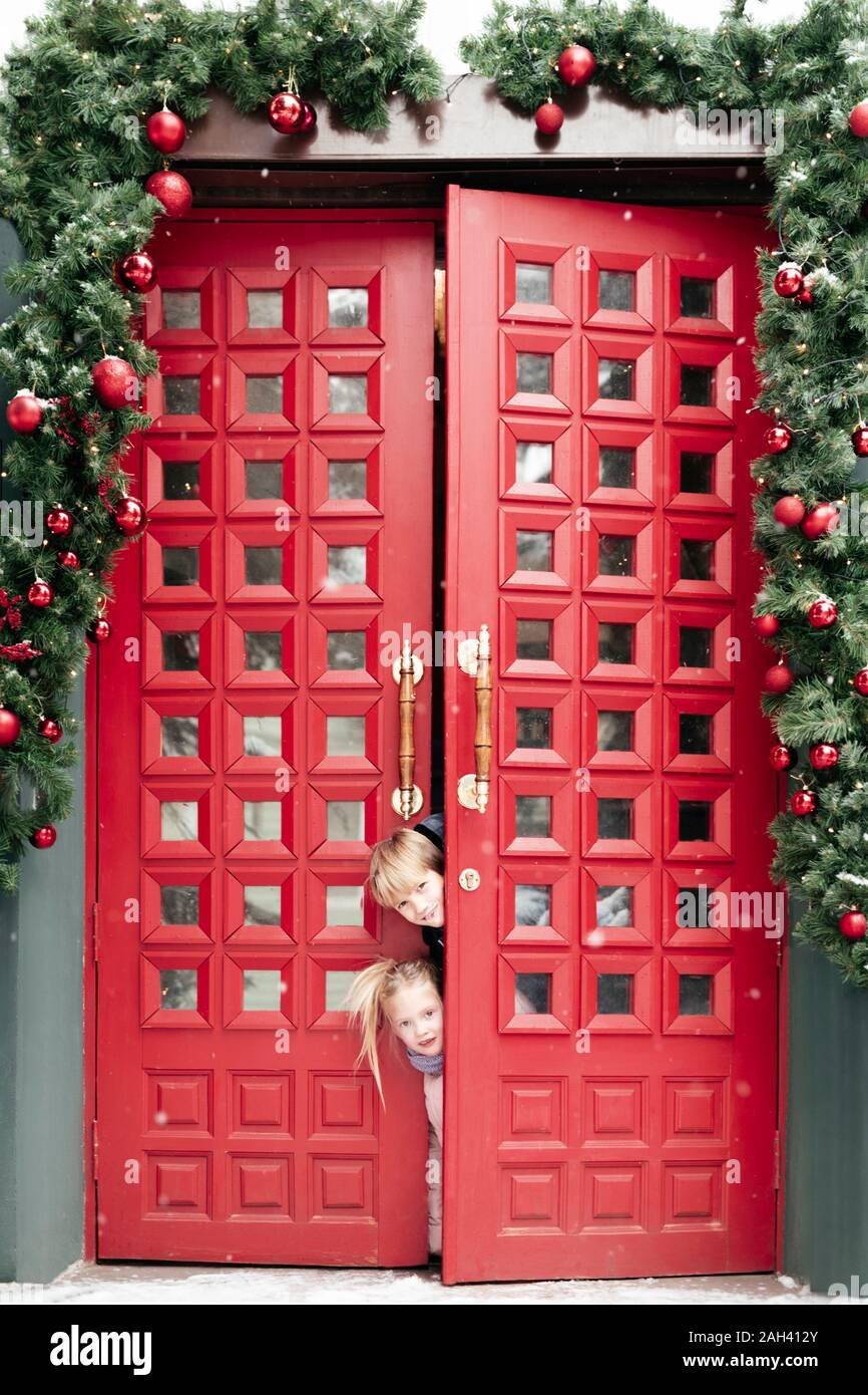 Portrait of siblings at doorway at Christmas time Stock Photo