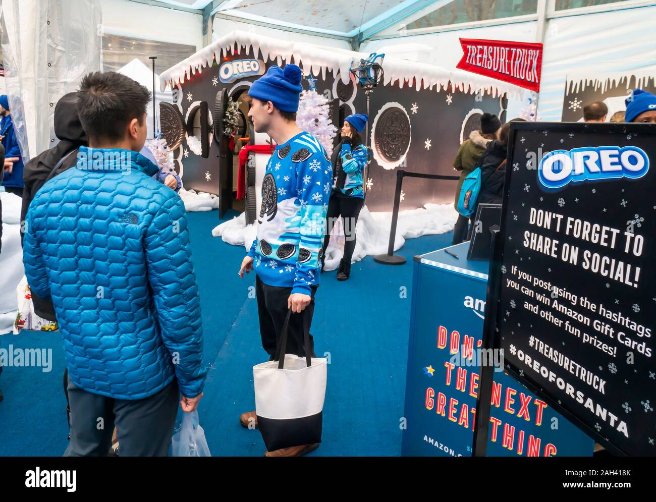 A brand ambassador in his ugly sweater from Nabisco’s Oreo cookies speaks with visitors at the Oreo Holiday House brand activation in Bryant Park in New York on Saturday, December 14, 2019.  (© Richard B. Levine) Stock Photo