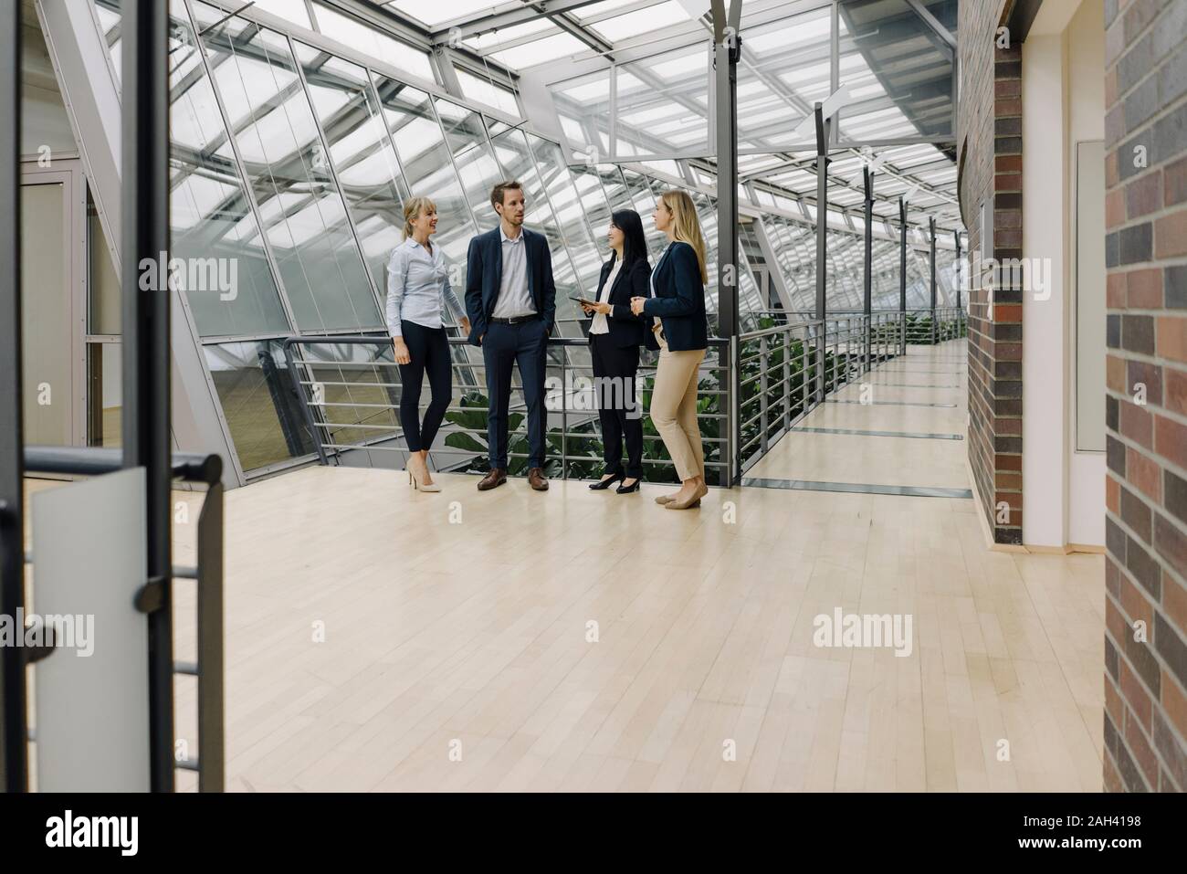 Business people talking in modern office building Stock Photo