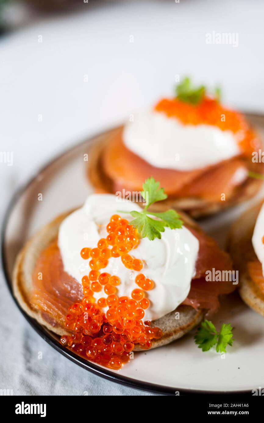 Blinis with sour cream, smoked salmon and fish roe Stock Photo