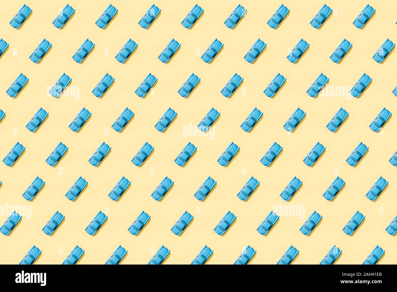 Vintage blue cars pattern on pastel yellow background Stock Photo