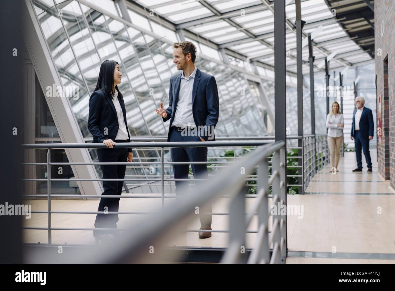 Business people talking in modern office building Stock Photo
