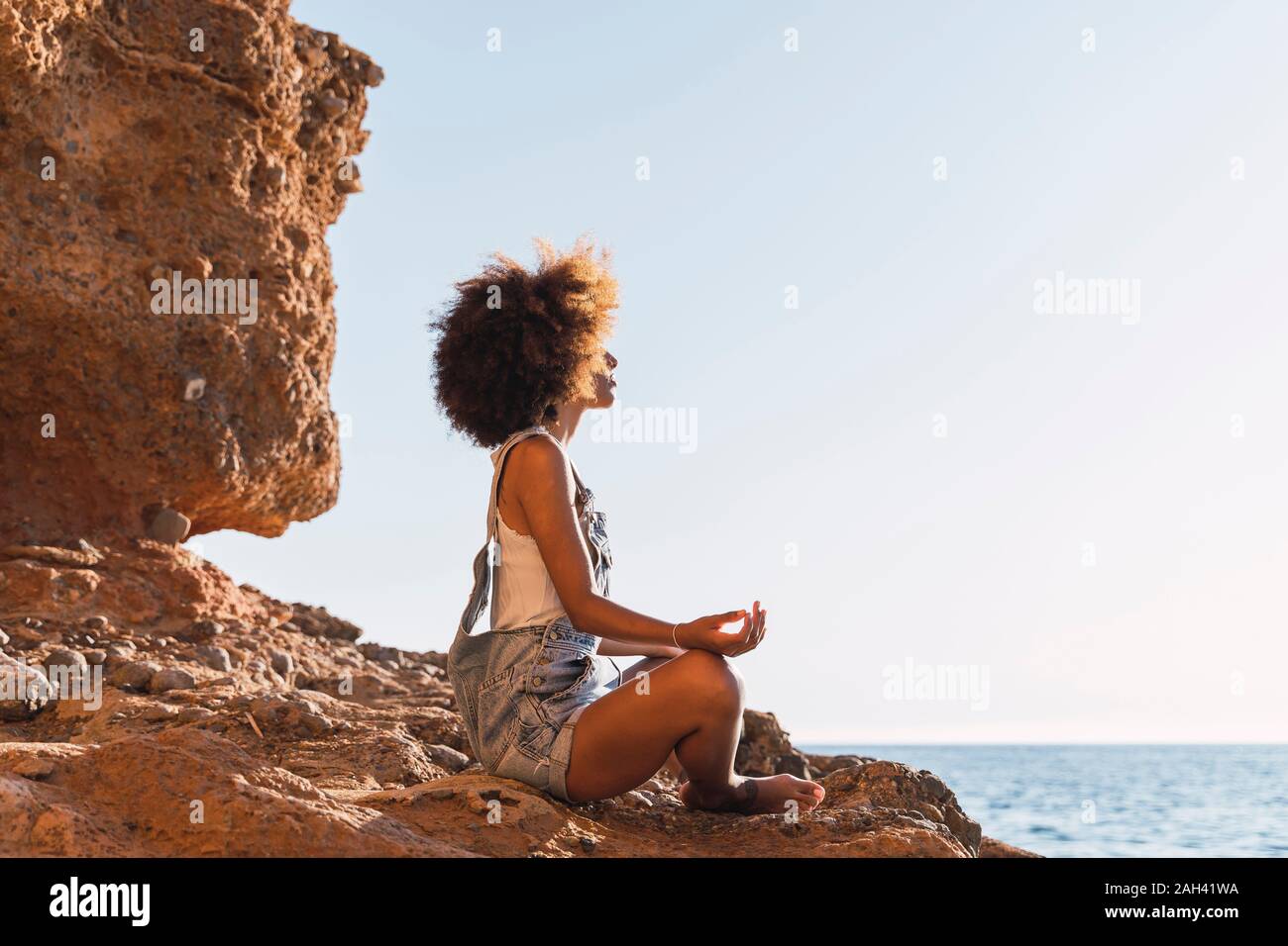 African woman sitting alone side view hi-res stock photography and ...