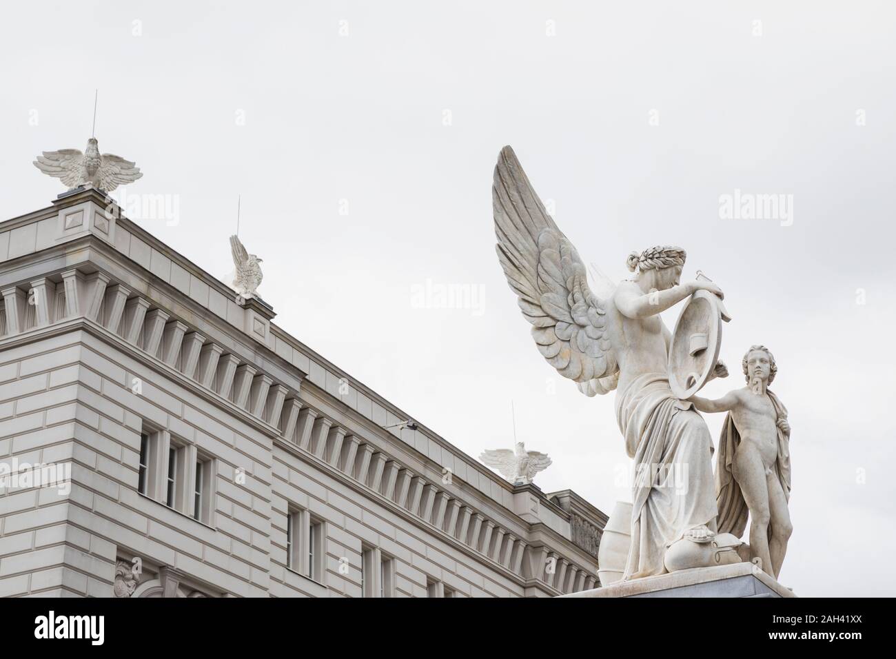 Germany, Berlin, Nike Instructs Boy in Heroic History statue with Humboldt Forum museum in background Stock Photo