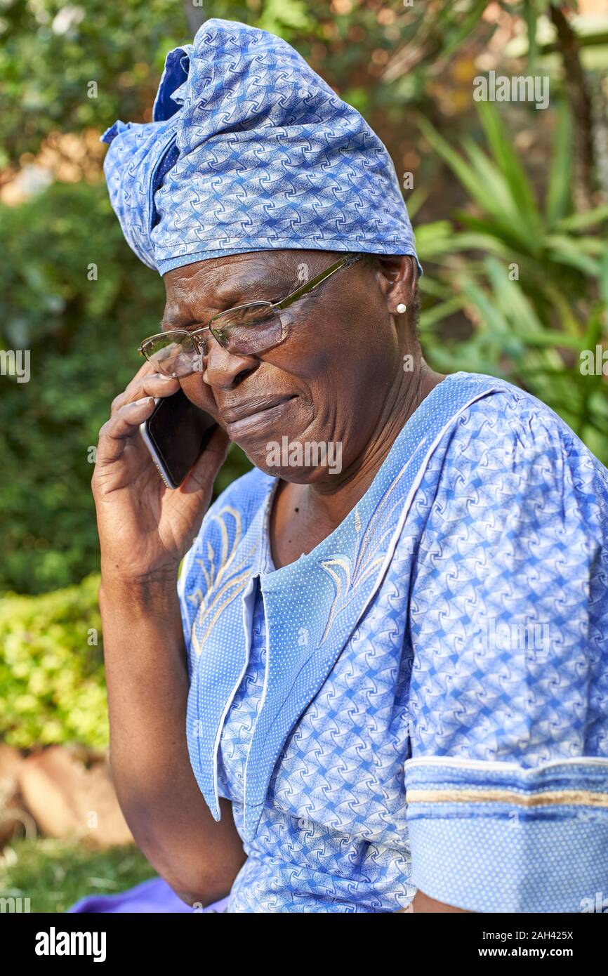 Senior woman on the phone outdoors Stock Photo