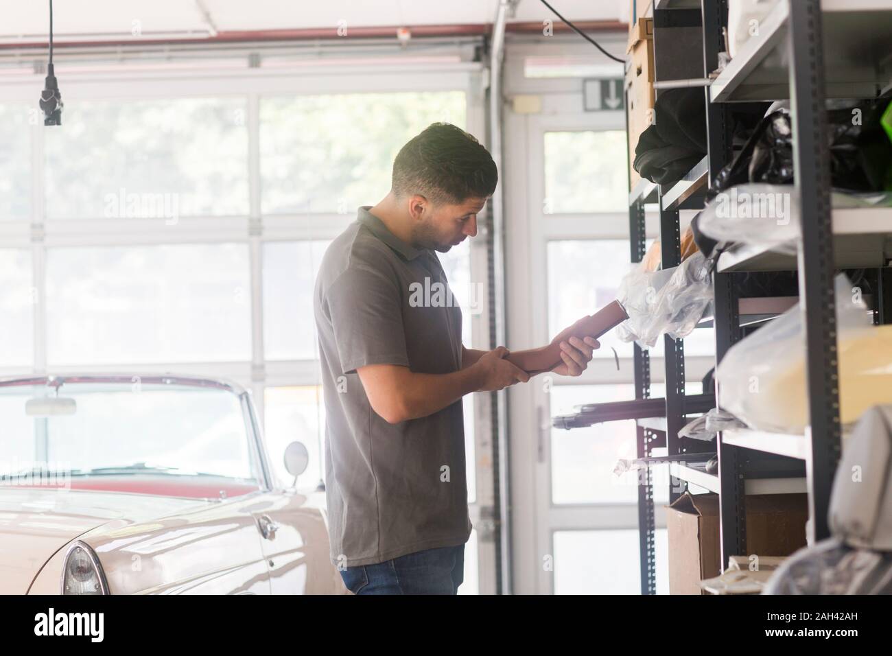 Young man working in a upholstery workshop Stock Photo