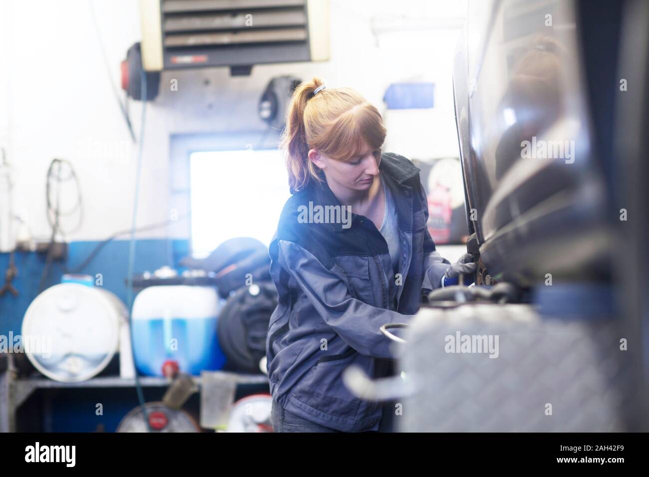 Female car mechanic working in repair garage Stock Photo