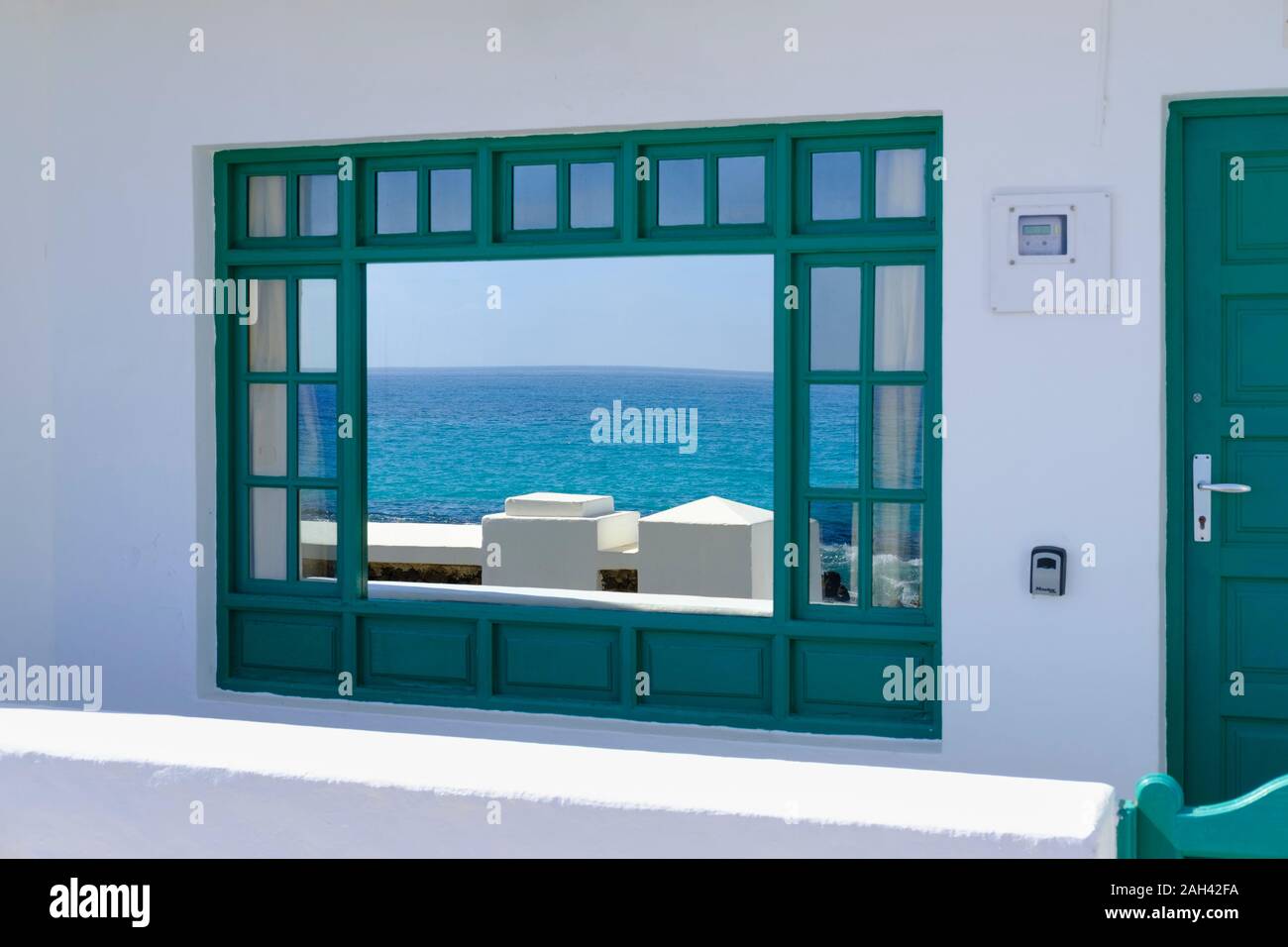 Spain, Canary Islands, Punta Mujeres, Atlantic Ocean reflecting in shiny window Stock Photo