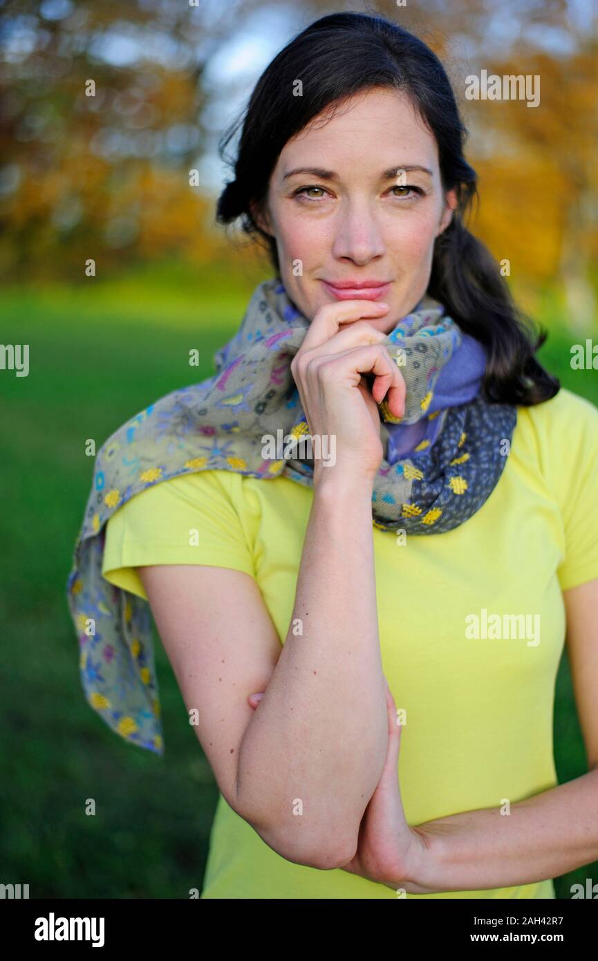 Portrait of woman in the nature, wearing green t-shirt and scarf Stock Photo