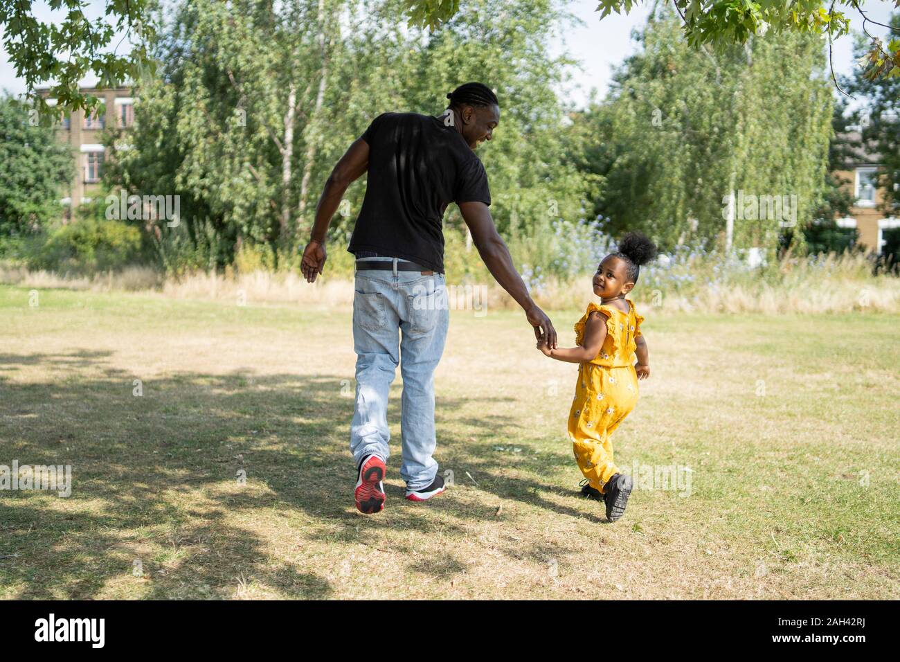 Child hand adult rear view hi-res stock photography and images - Alamy