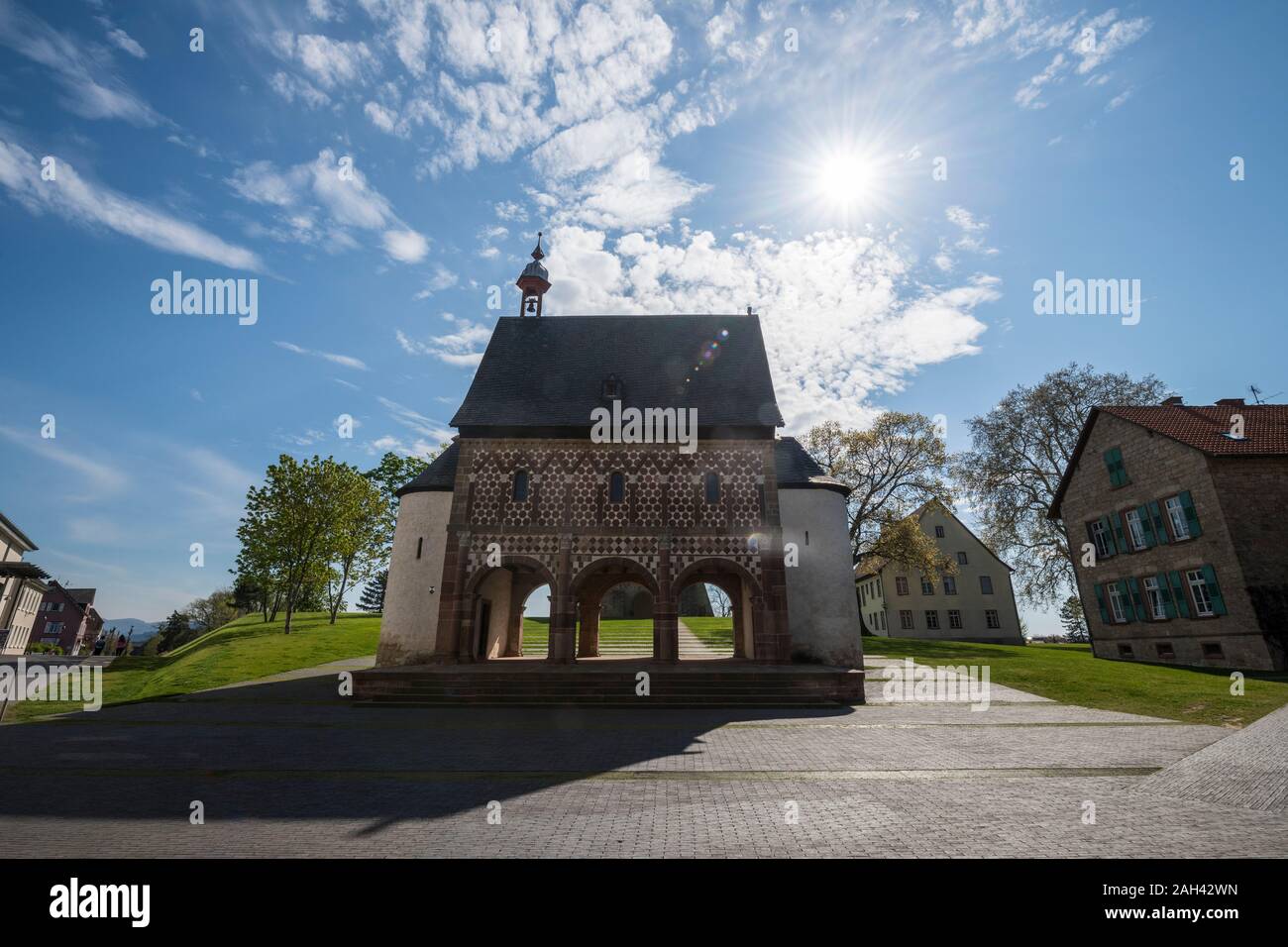 Germany, Hesse, Lorsch, Sun shining over Torhalle of Lorsch Abbey Stock Photo