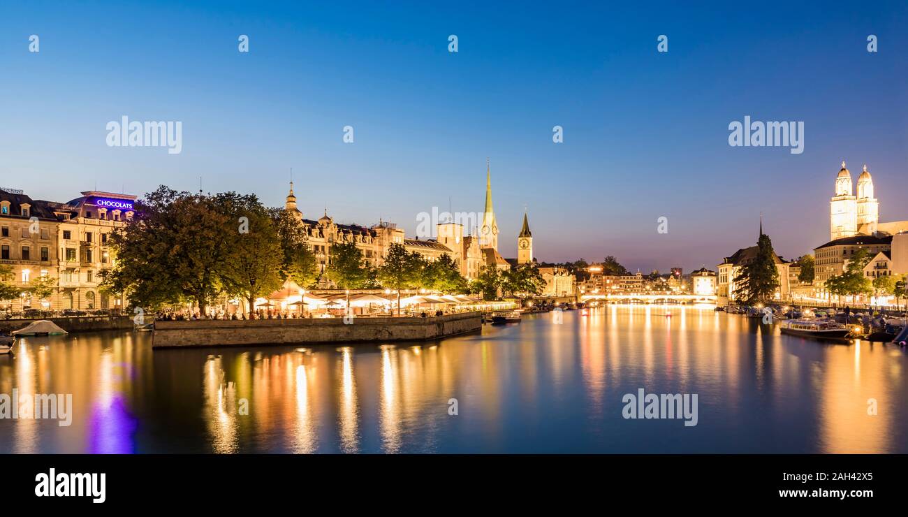 Switzerland, Canton of Zurich, Zurich, River Limmat and illuminated old town waterfront buildings at dusk Stock Photo