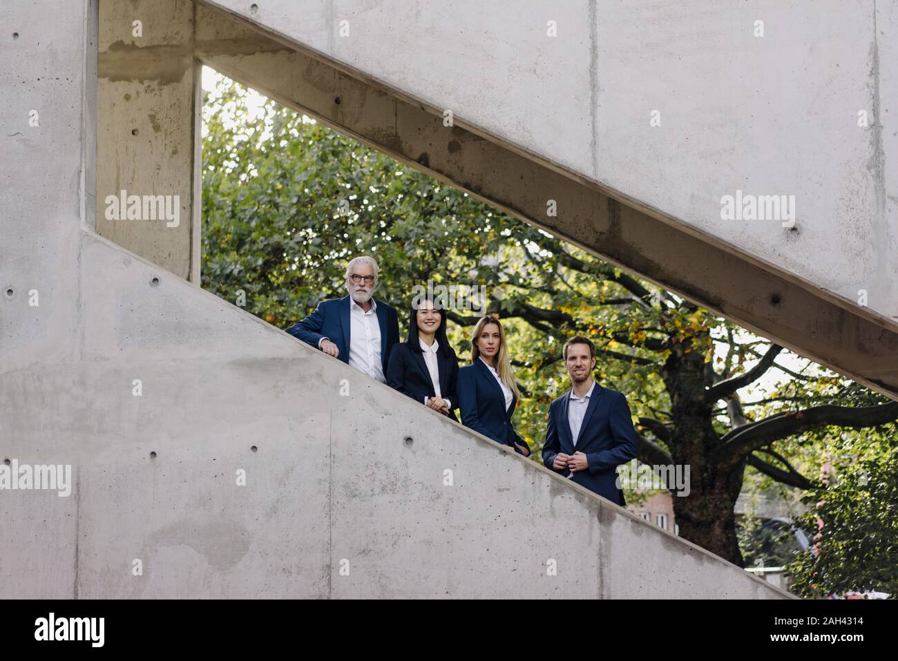 Portrait of confident business people on exterior stair Stock Photo