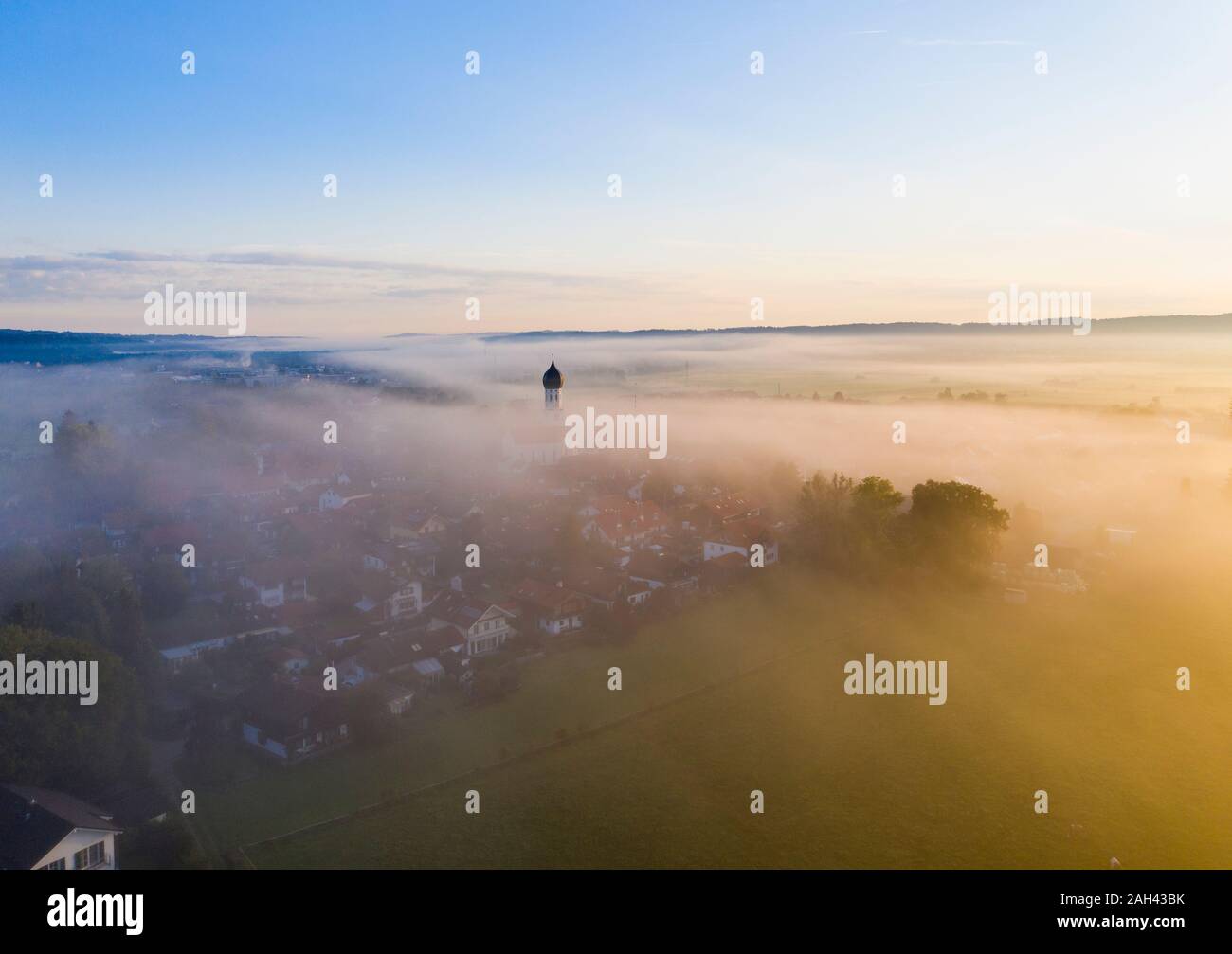 Germany, Bavaria, Geretsried, Aerial view of countryside town shrouded in morning fog Stock Photo