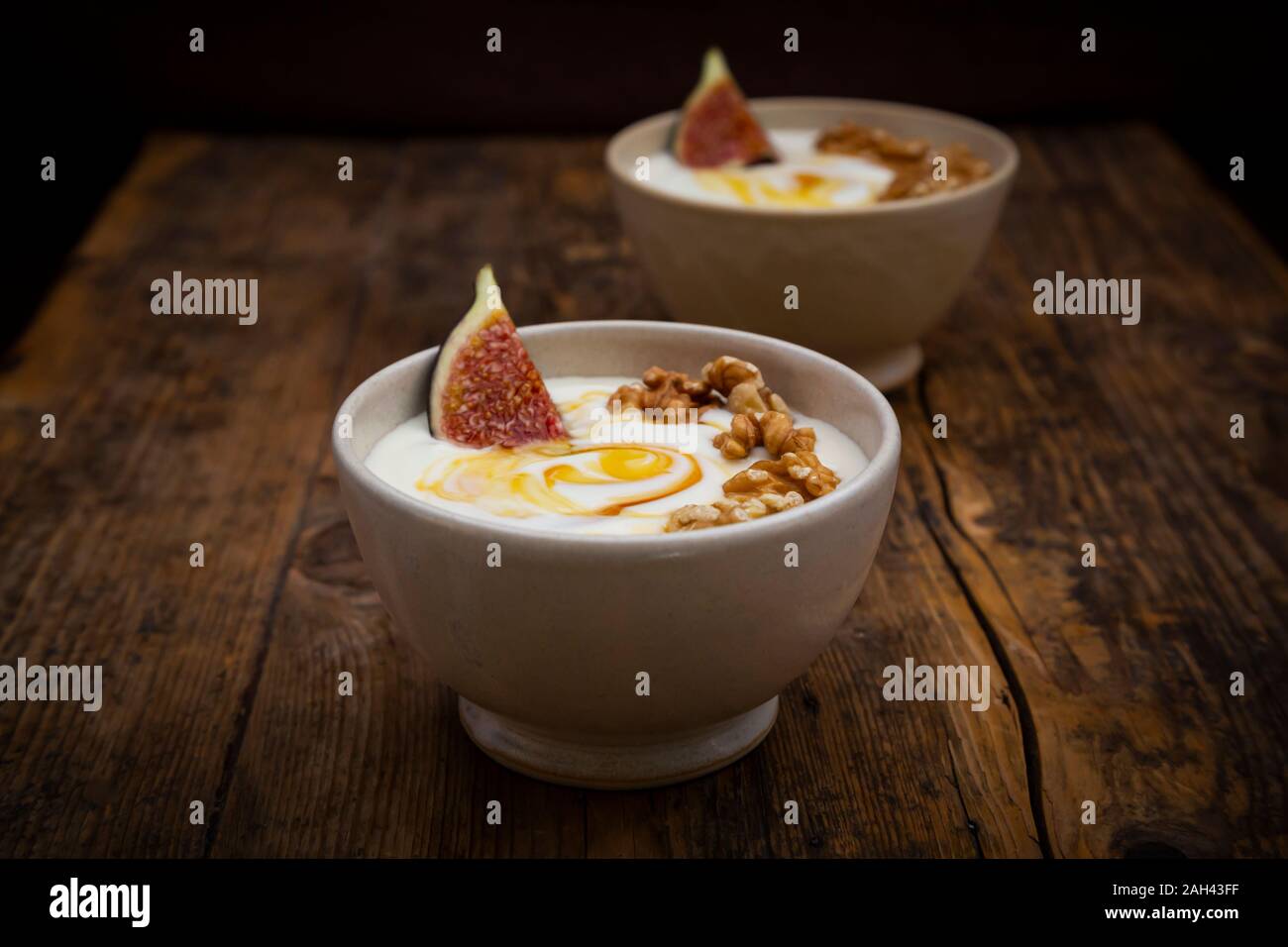 Bowls of Greek yogurt with honey, walnuts and fig Stock Photo Alamy