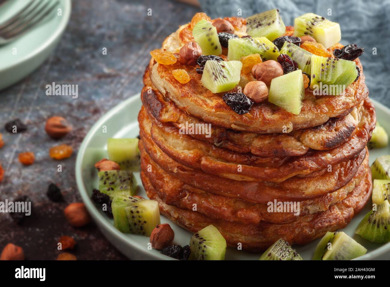 Cup of coffee with milk and a plate with pancakes on a white table. Stock Photo