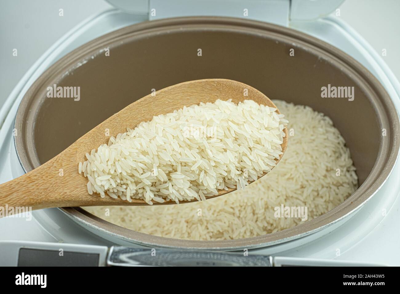 Close up Jasmine rice cooking in electric rice cooker at white