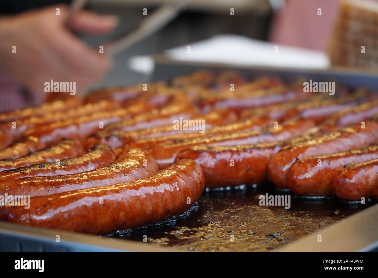 Prague, Czech Republic 2019:Traditional hot dog preparation on coal fire on the street during the Christmas market Stock Photo