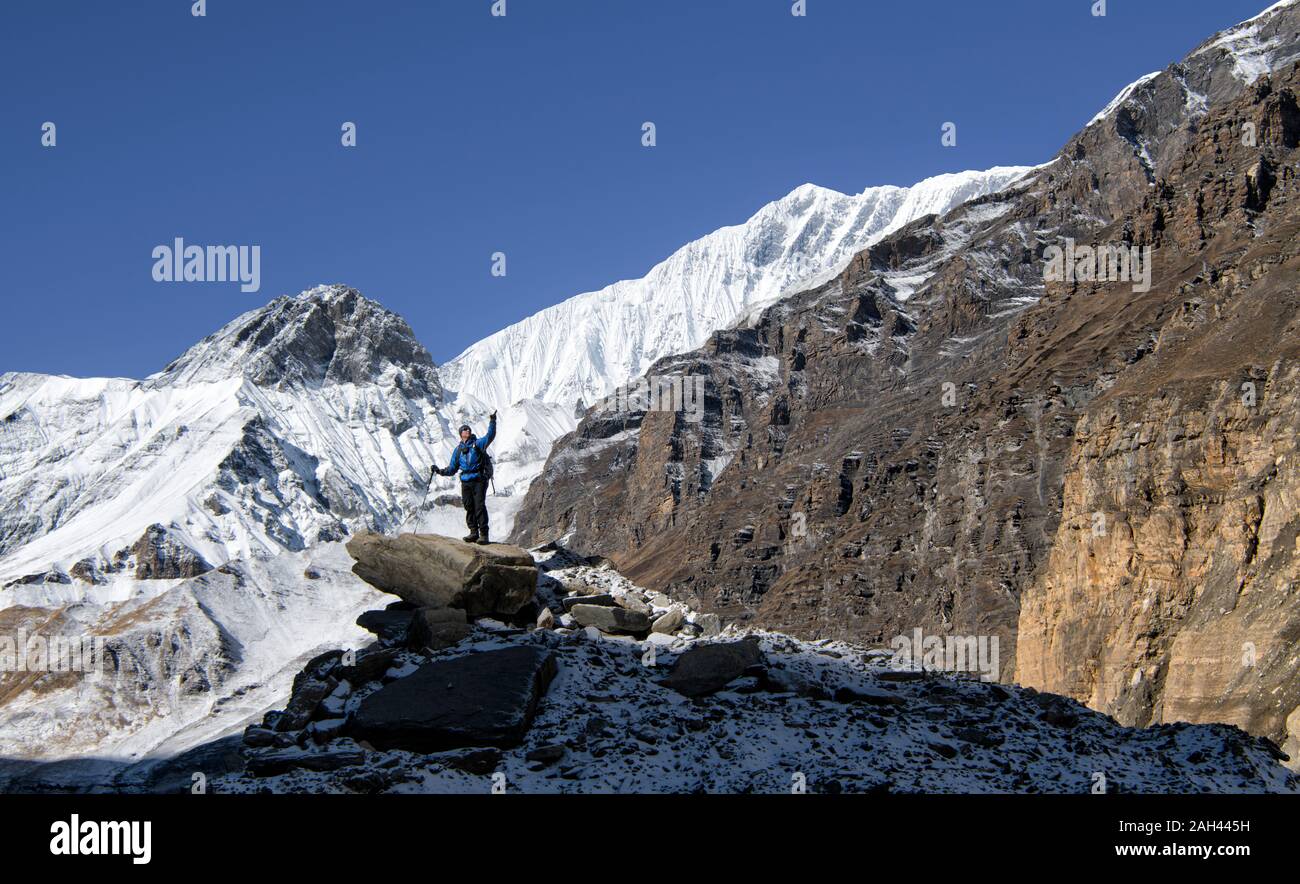 Mountaineer on top of a rock, Dhaulagiri Circuit Trek, Himalaya, Nepal Stock Photo
