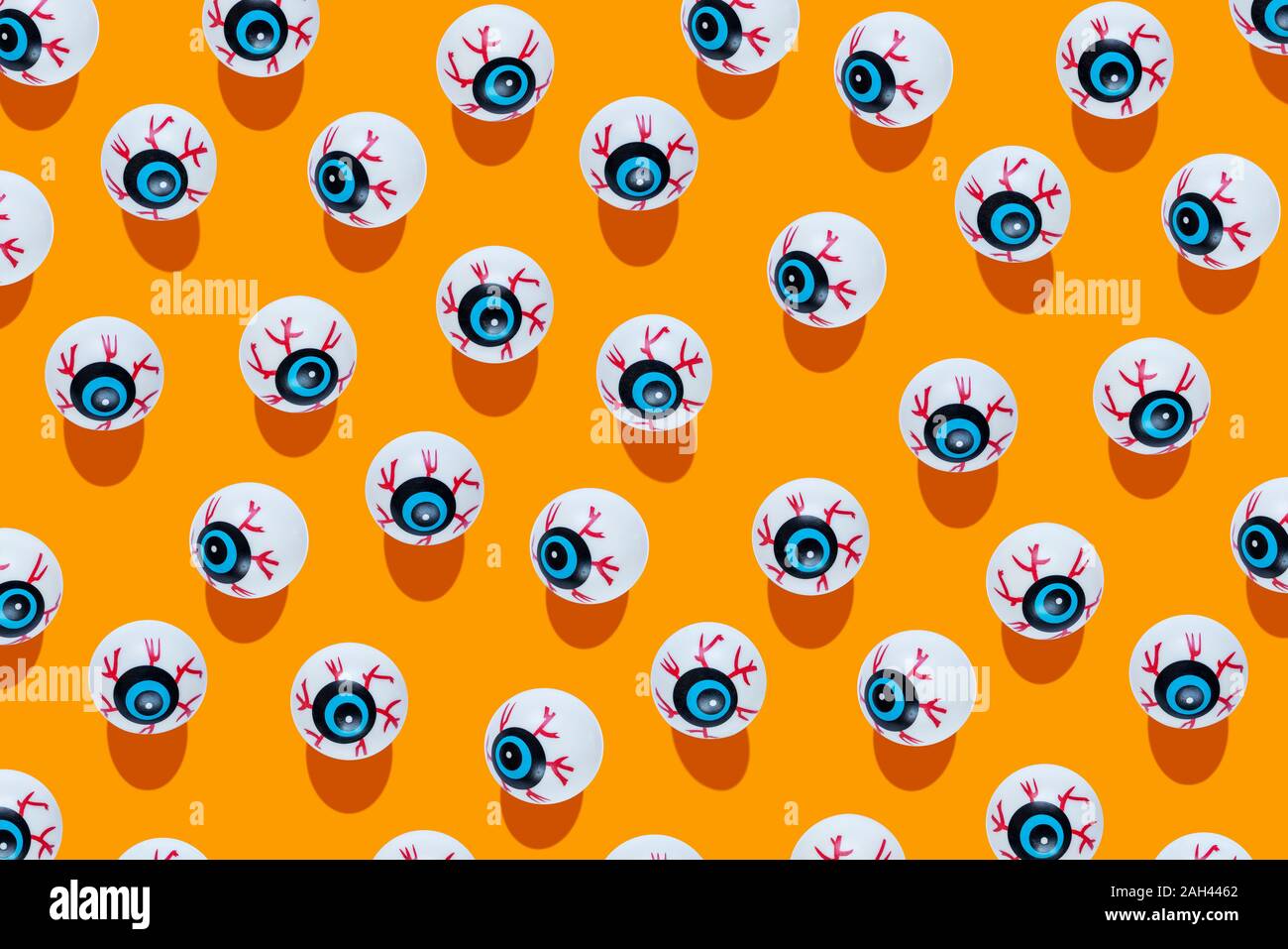 Fake scary eyeballs for halloween on orange background Stock Photo