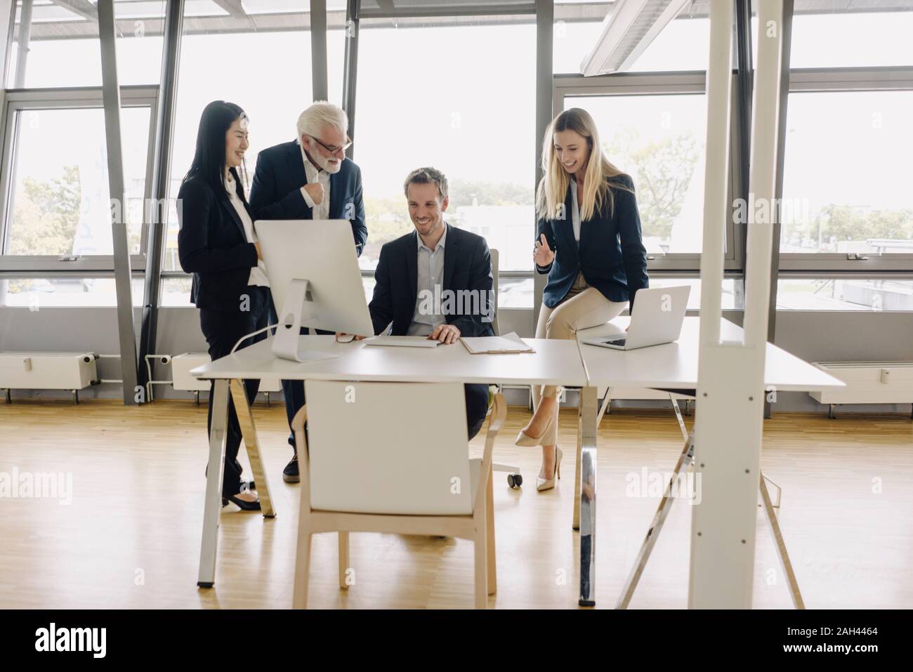 Happy business people having a meeting in office Stock Photo - Alamy