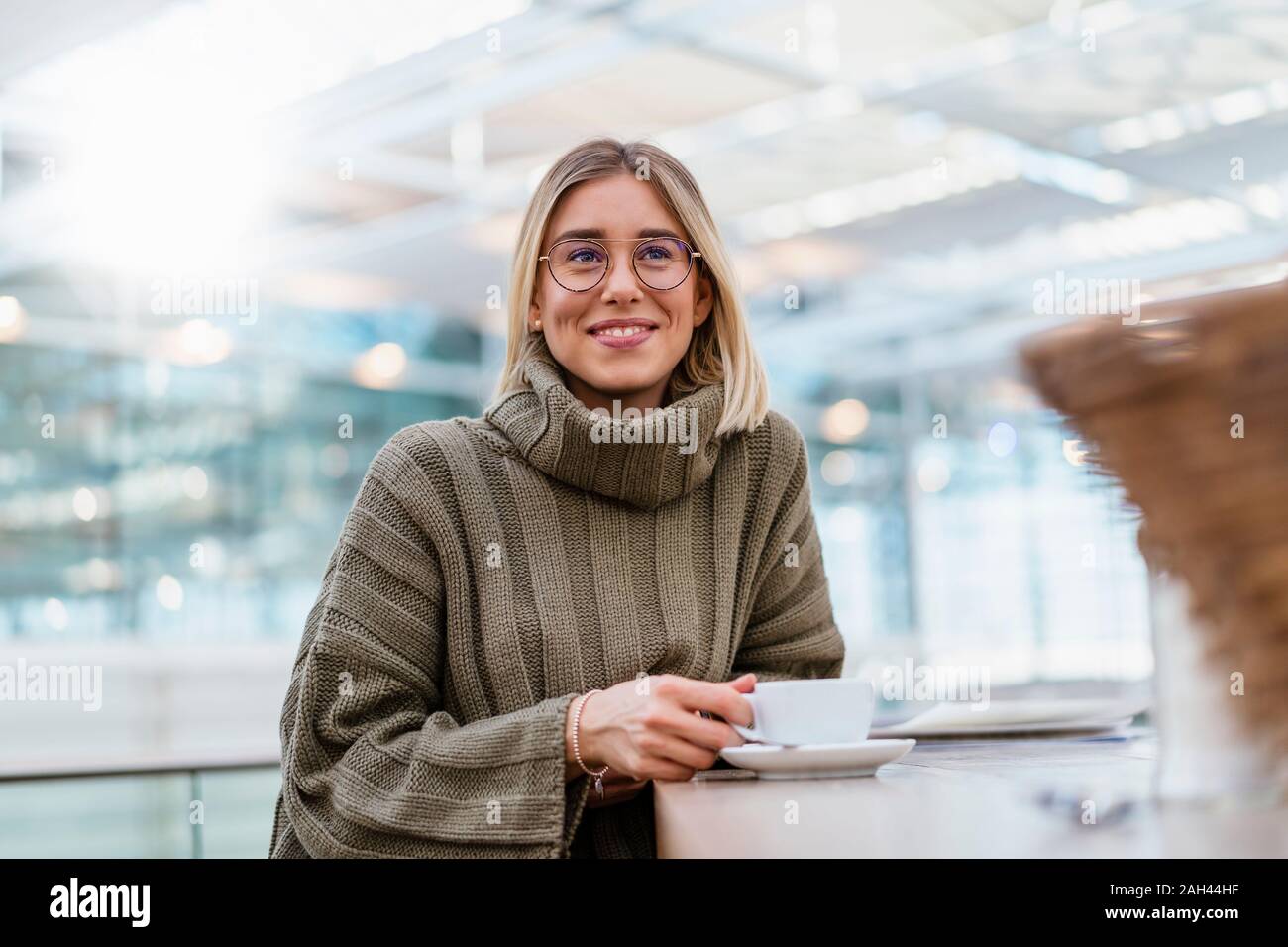 Portrait of a smiling young woman in a cafe Stock Photo