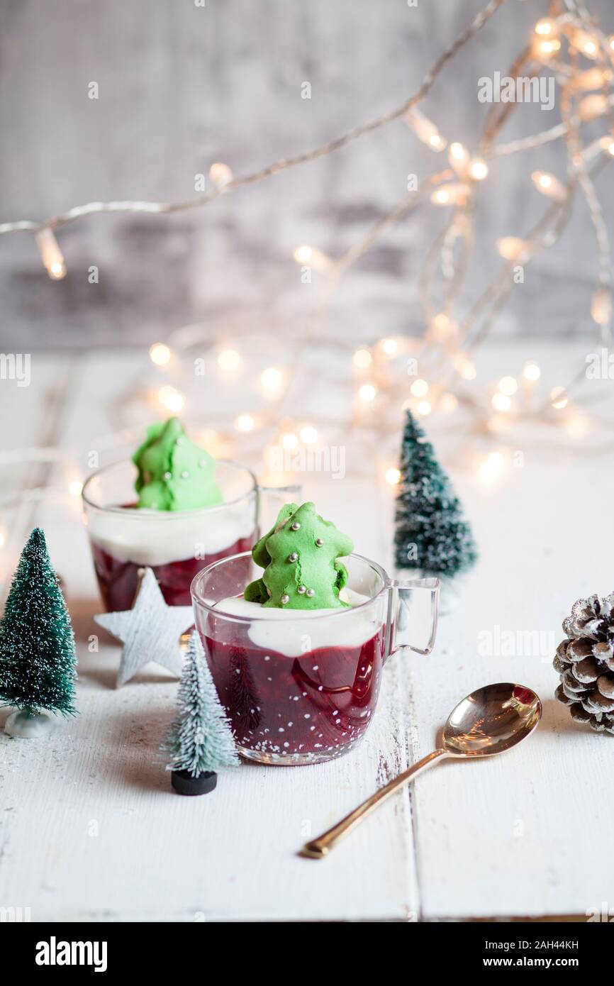 Cups of red porridge with green macaroon Christmas trees Stock Photo
