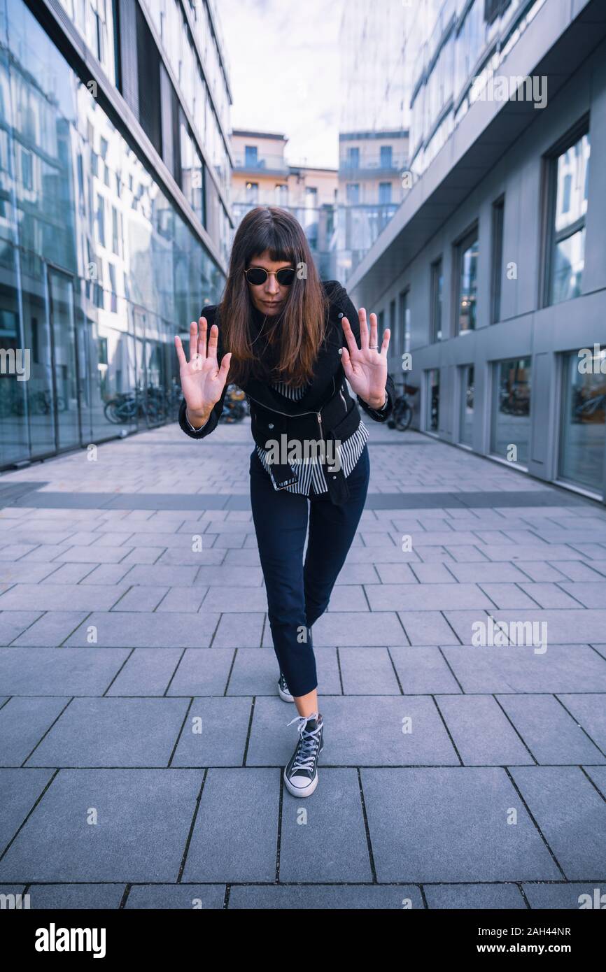 Women with sun glasses in urban location, posing artistically Stock Photo