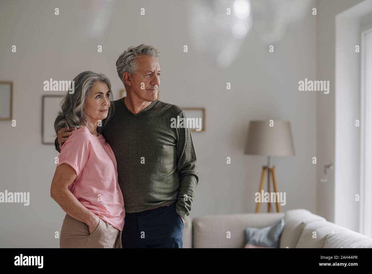 Senior couple standing in living room at home Stock Photo