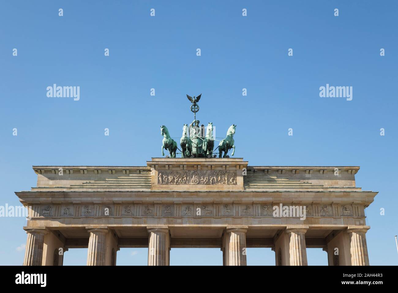Germany, Berlin, Low angle view of Brandenburg Gate standing against clear blue sky Stock Photo