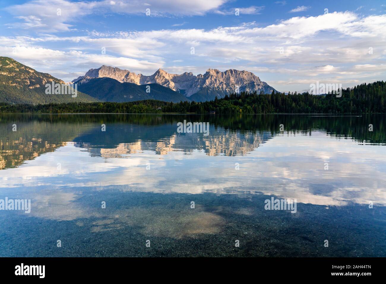 Germany, Bavaria, Scenic view of Wetterstein mountains reflecting in Barmsee lake Stock Photo