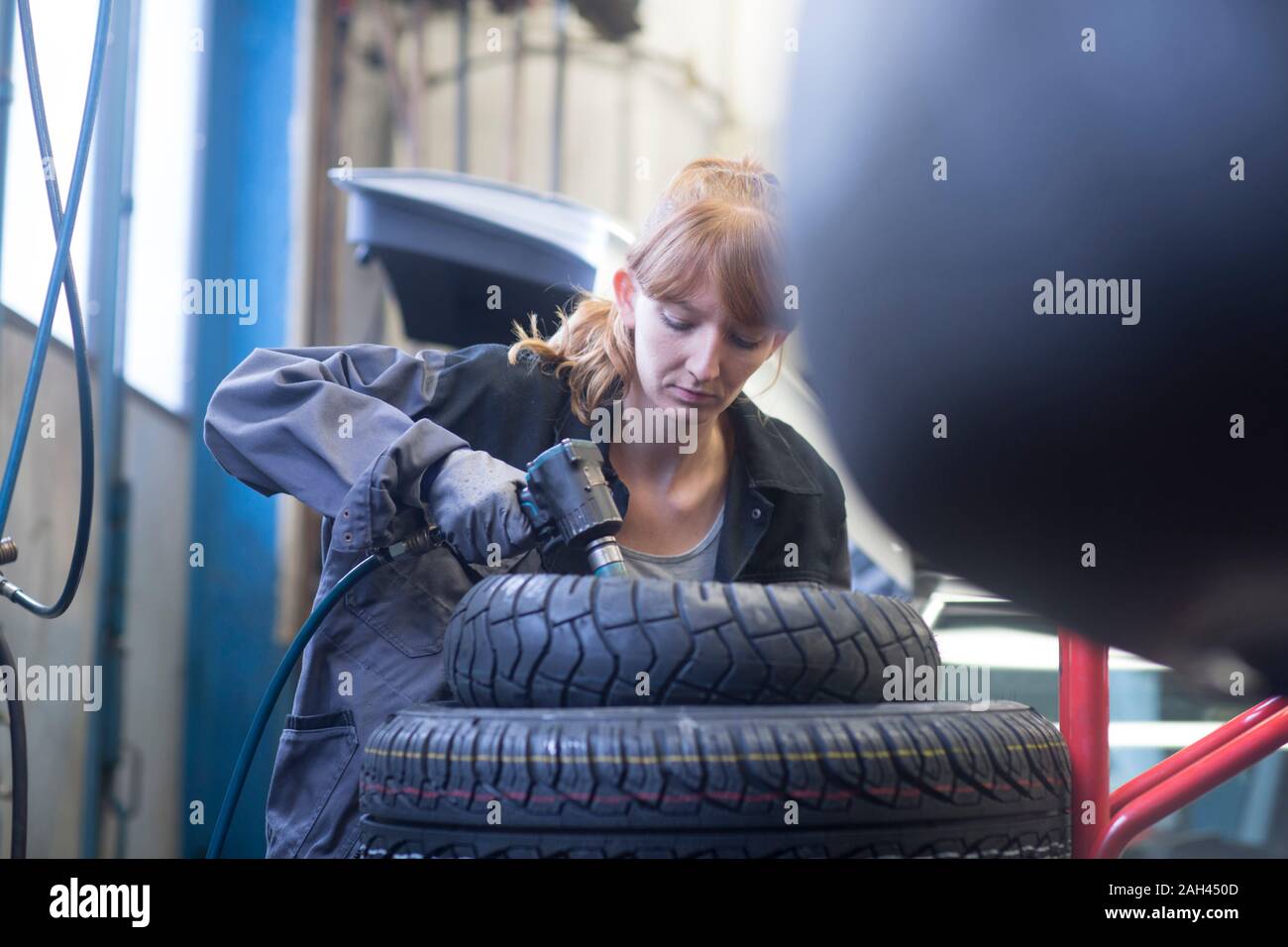 Female car mechanic working in repair garage Stock Photo