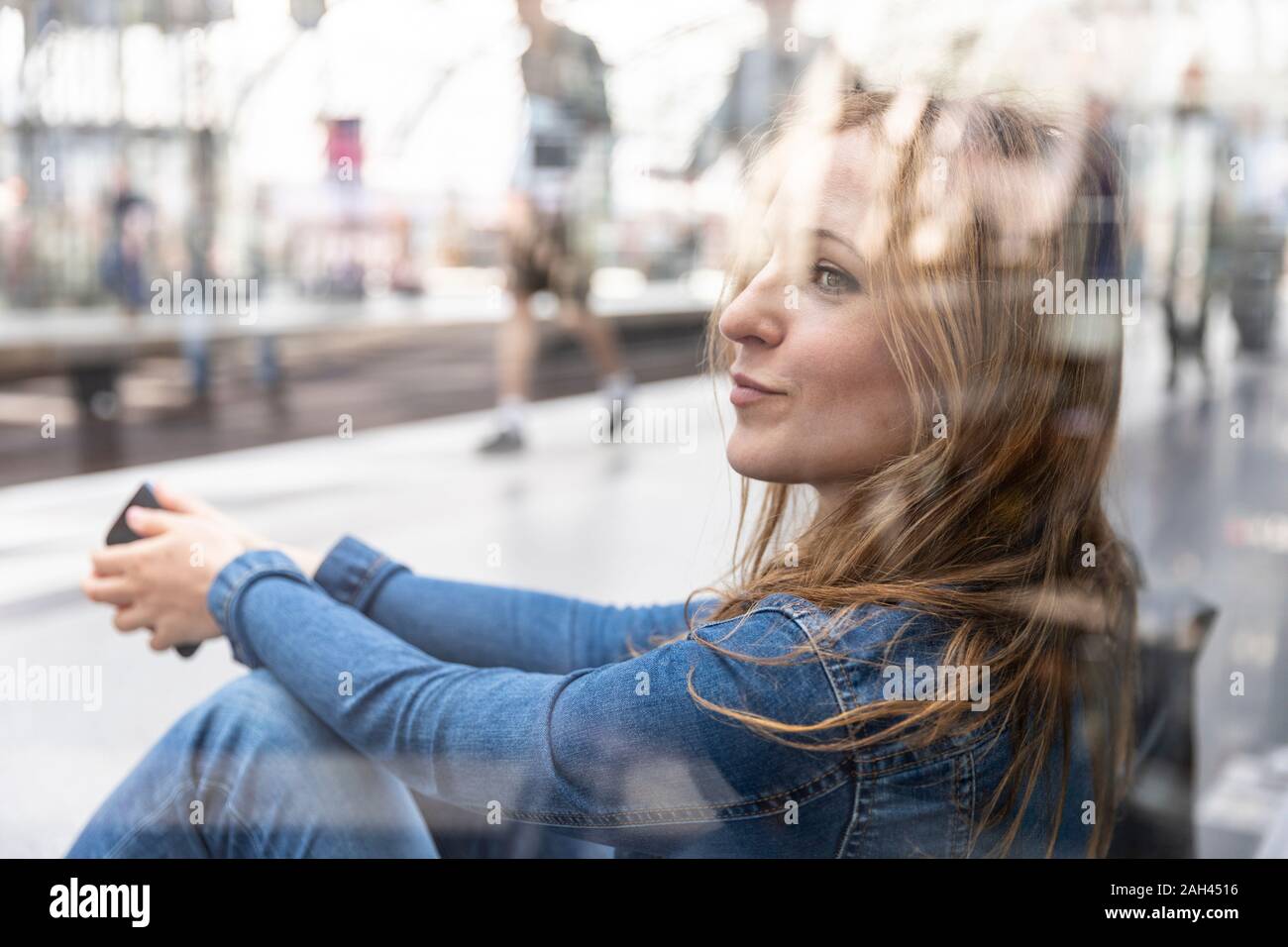 Woman waiting at the train station, Berlin, Germany Stock Photo