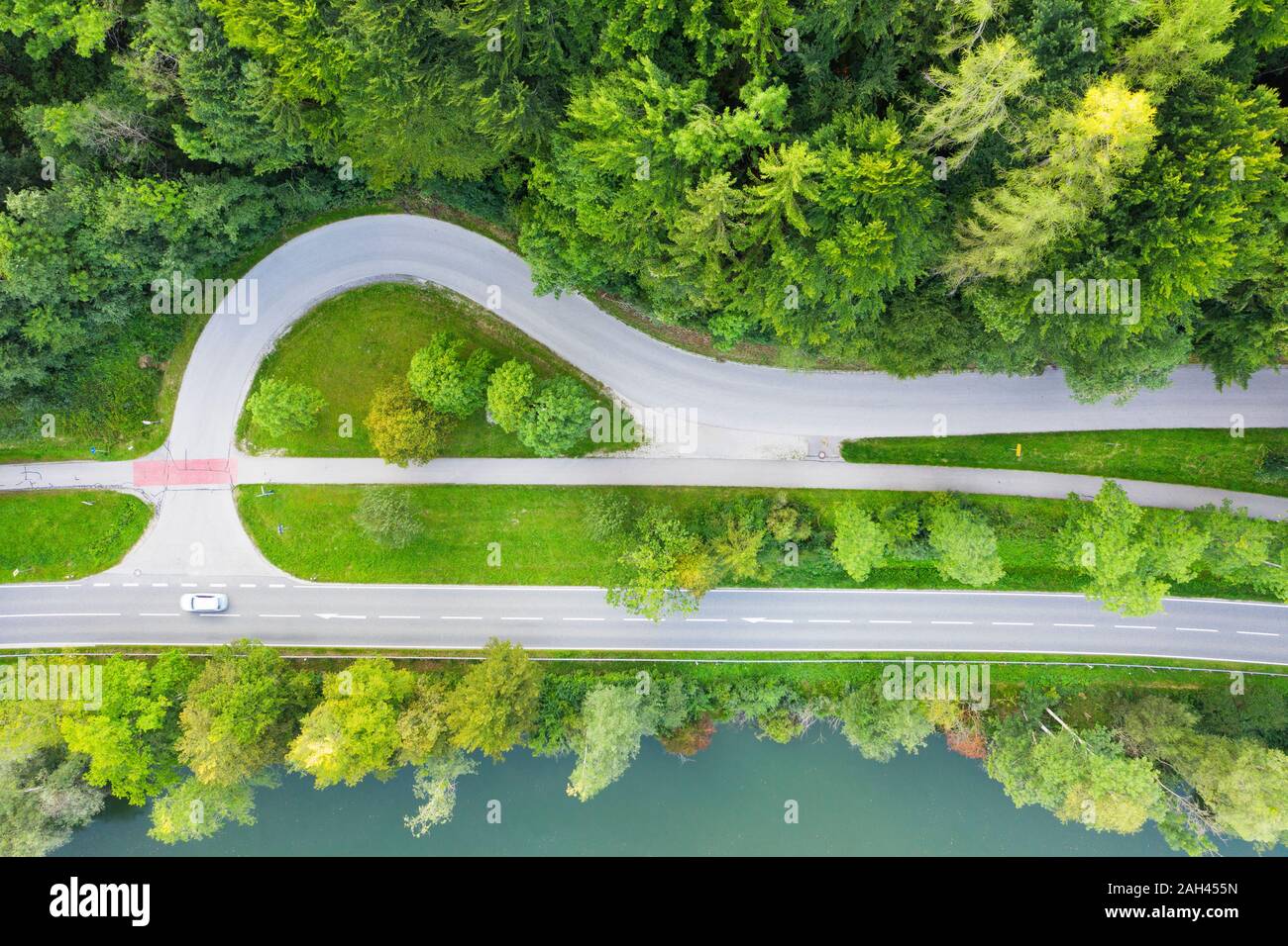Germany, Bavaria, Eurasburg, Aerial view of edge of green spruce forest and junction of countryside highway Stock Photo