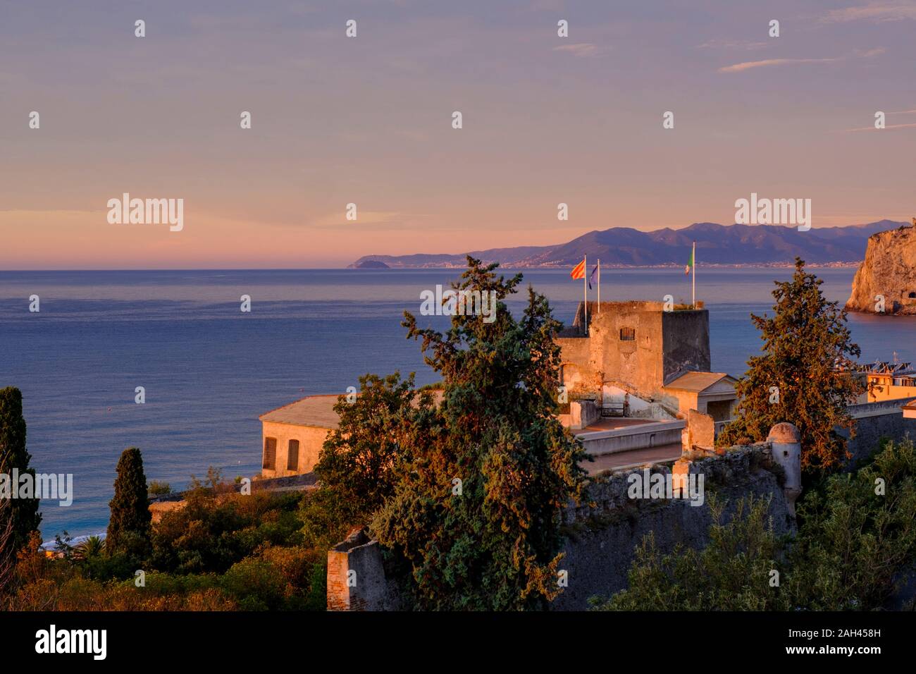 Italy, Liguria, Riviera di Ponente, Finale Ligure, La Fortezza and sea at sunrise Stock Photo