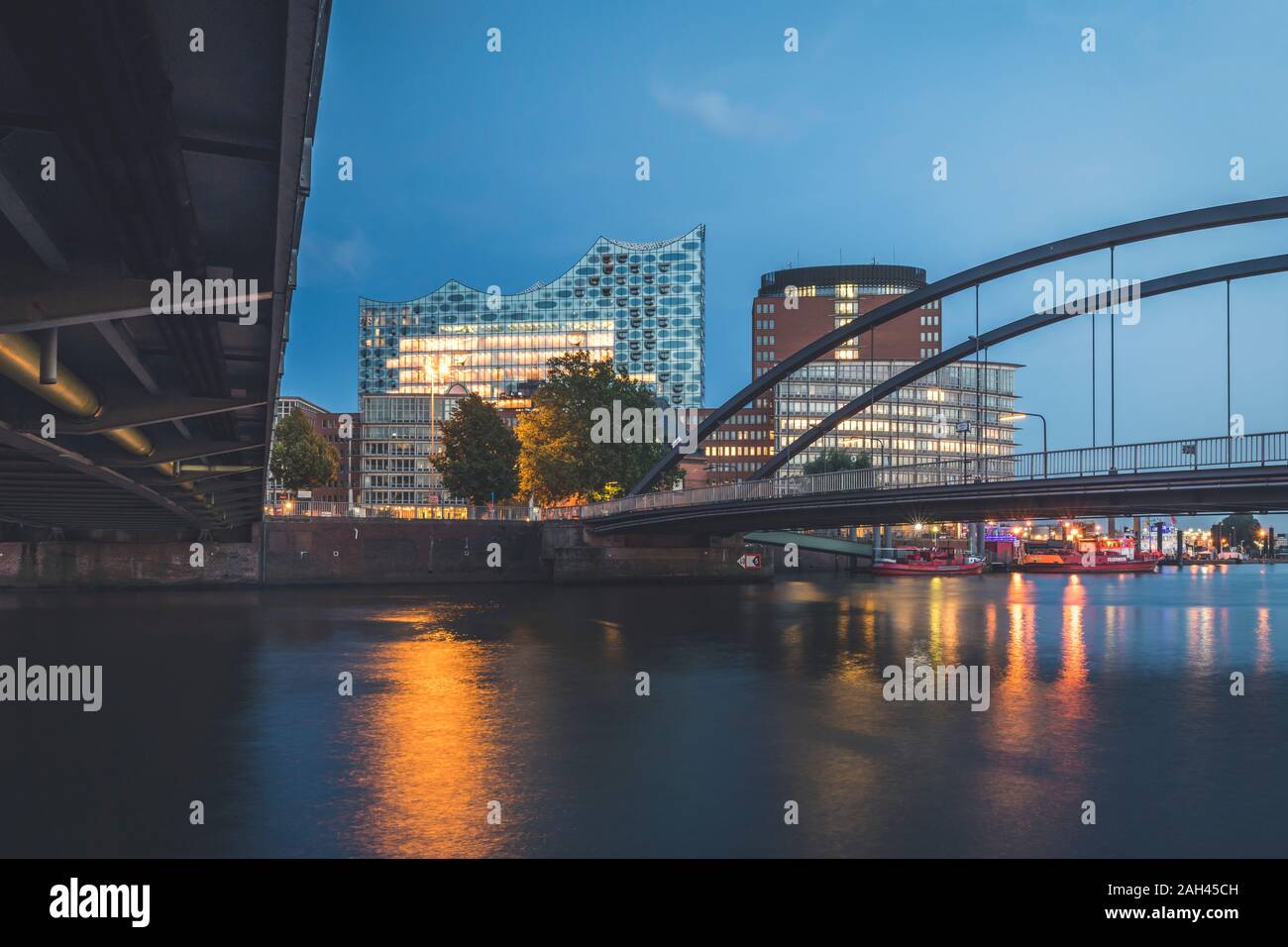 Germany, Hamburg, Niederbaumbrucken and Elbphilharmonie at dusk Stock Photo