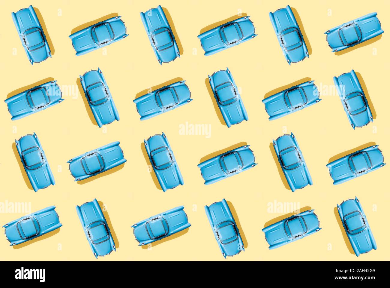 Vintage blue cars pattern on pastel yellow background Stock Photo