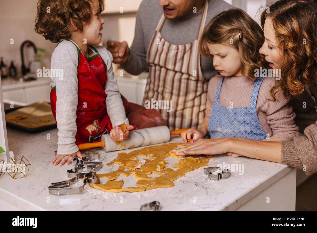 Family preparing Christmas cookies in kitchen Stock Photo