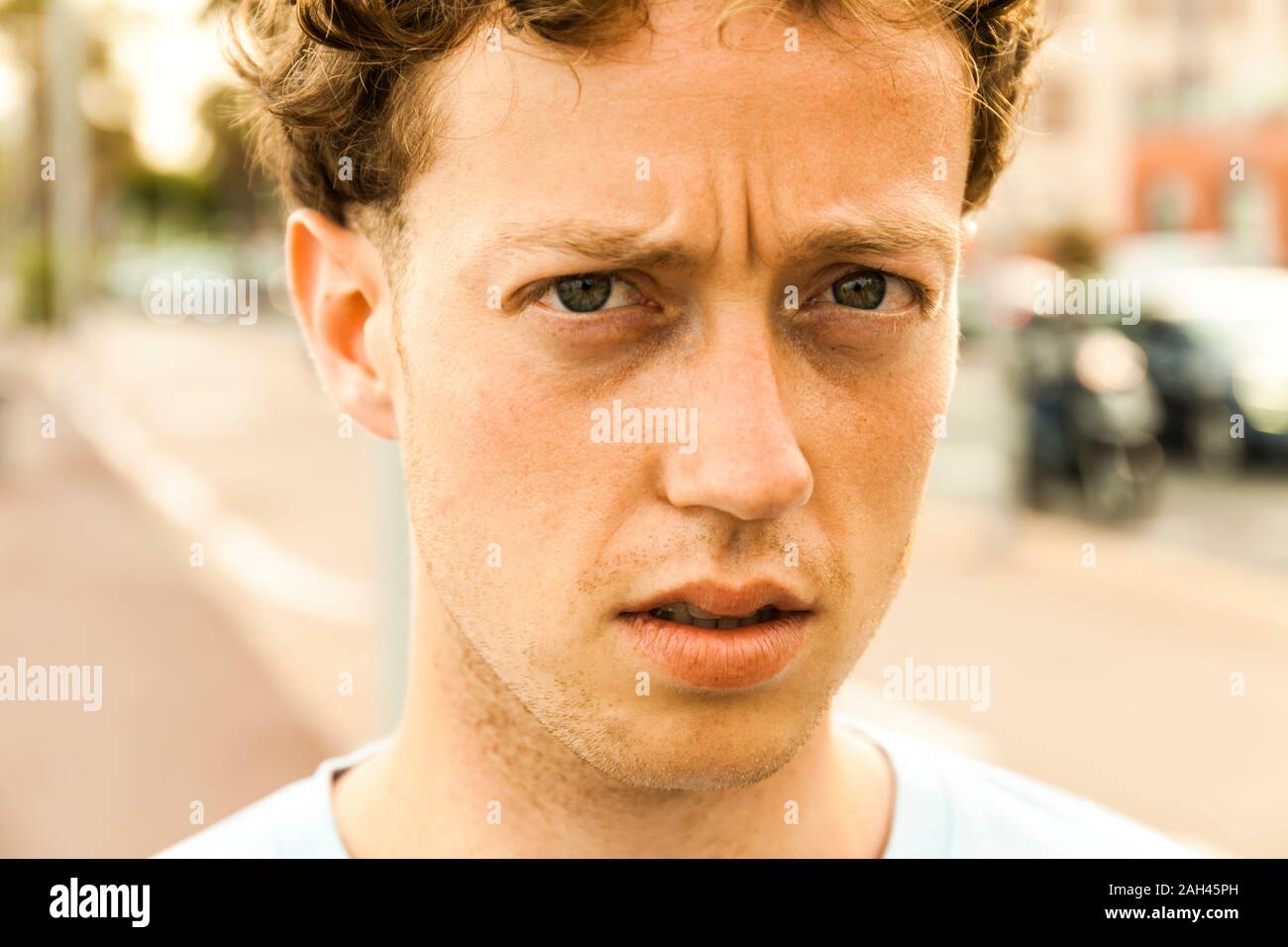 Portrait of sceptical young strawberry blonde man Stock Photo