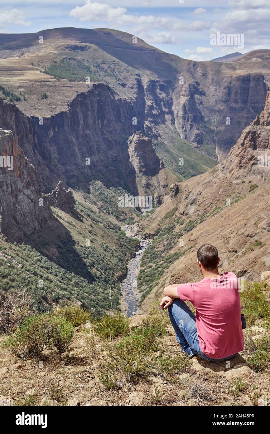 Man sitting on top of a hill at Maletsunyane Falls enjoying the view, Lesotho Stock Photo