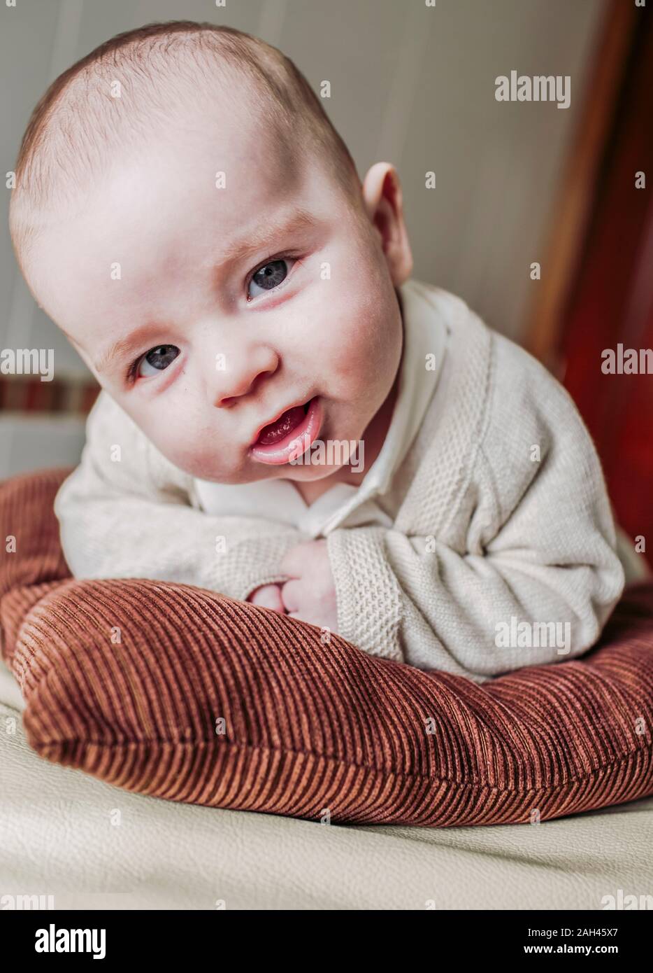 Portrait of baby boy lying on a bed Stock Photo