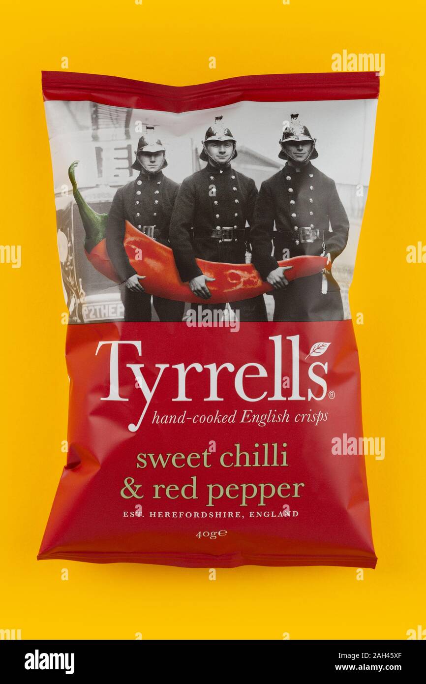 A packet of Tyrrells crisps shot on a yellow background. Stock Photo