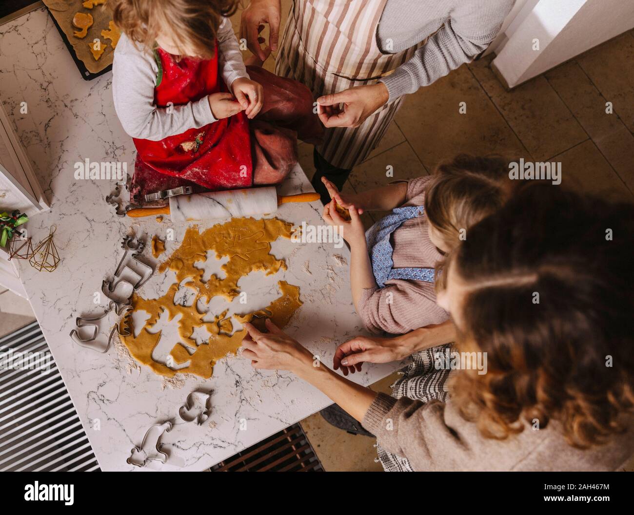 Family preparing Christmas cookies in kitchen Stock Photo